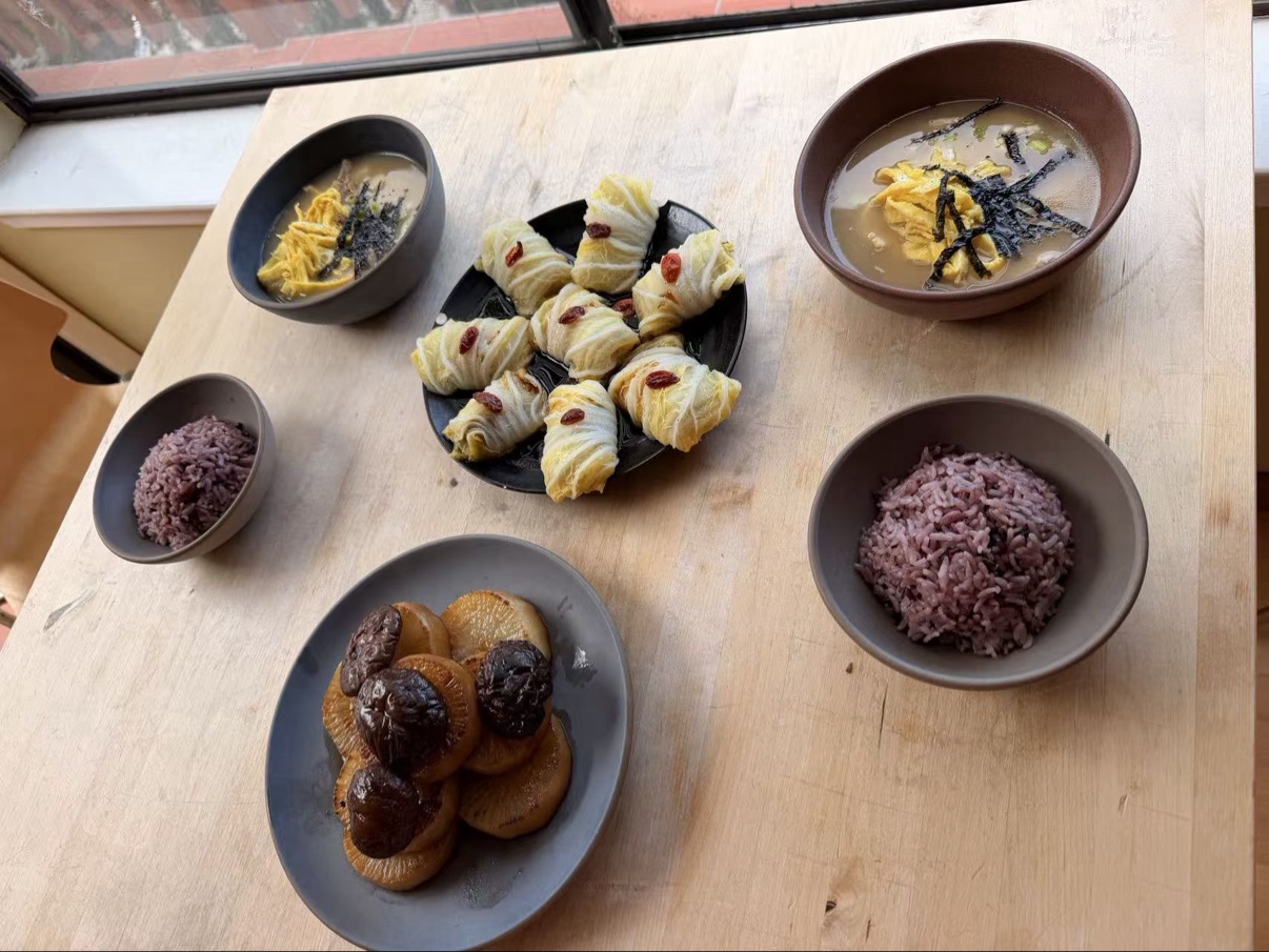Postpartum meal spread with cabbage rolls and soups
